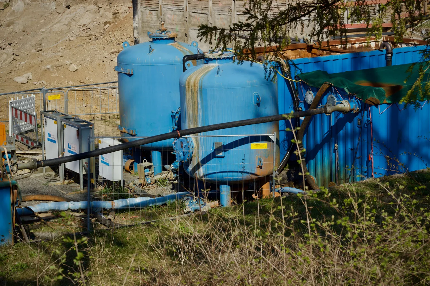 Outdoor industrial water-filtration equipment with tanks and piping