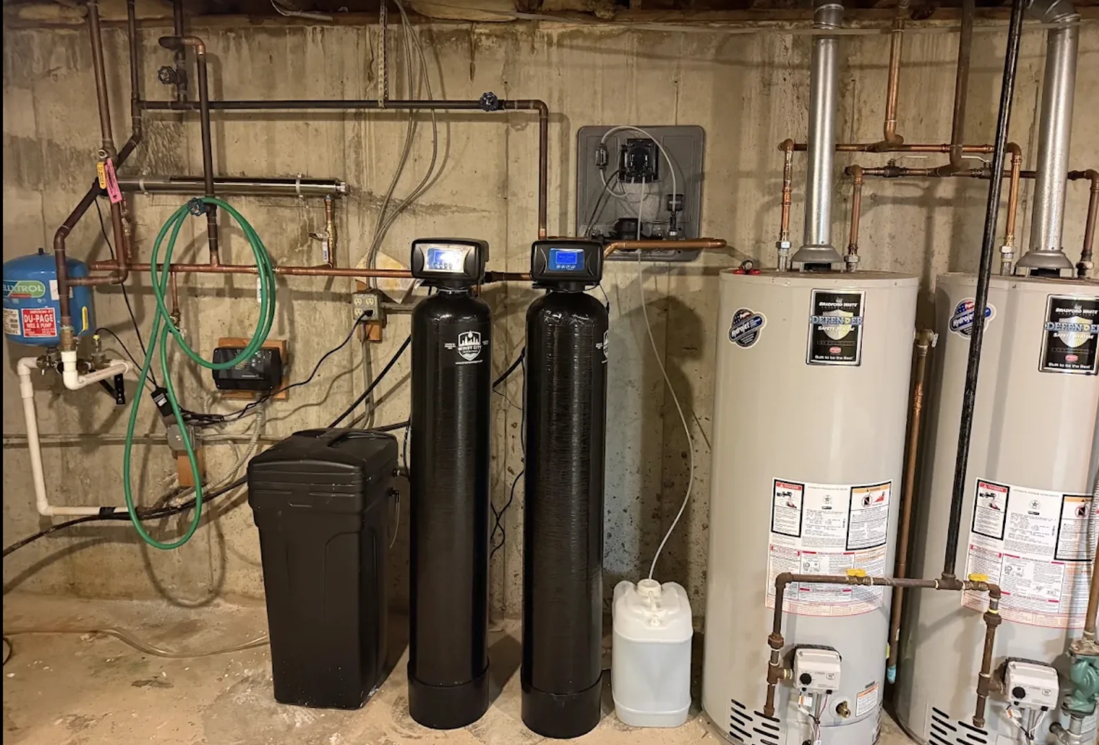 Residential whole-home water treatment installed beside water heaters